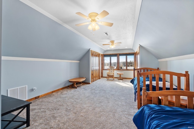 bedroom with carpet floors, baseboards, visible vents, and vaulted ceiling