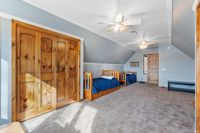 bedroom with lofted ceiling, carpet floors, visible vents, and a ceiling fan