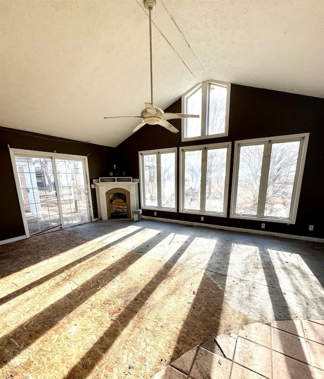 unfurnished living room featuring a fireplace, vaulted ceiling, and a textured ceiling