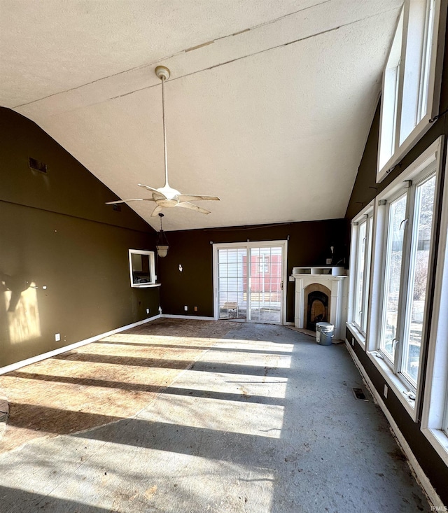 unfurnished living room featuring high vaulted ceiling, visible vents, a fireplace, and baseboards