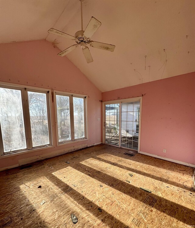 empty room featuring visible vents, high vaulted ceiling, and a ceiling fan