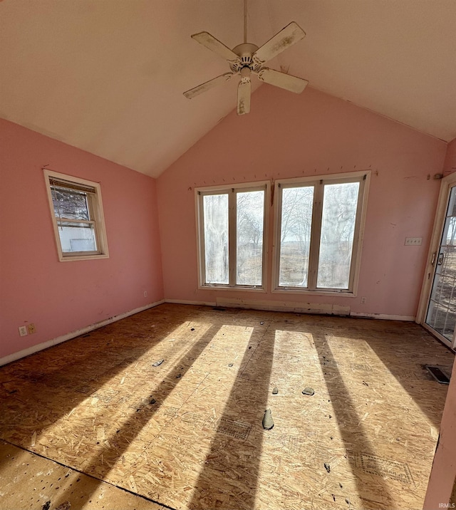 unfurnished room with ceiling fan, plenty of natural light, and vaulted ceiling