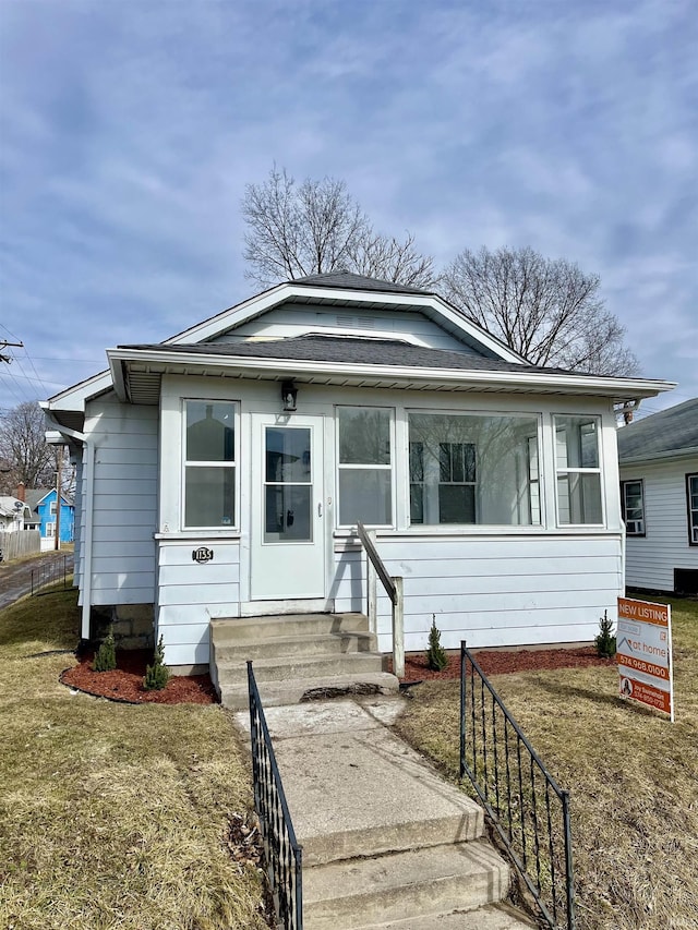 bungalow-style home featuring a front yard