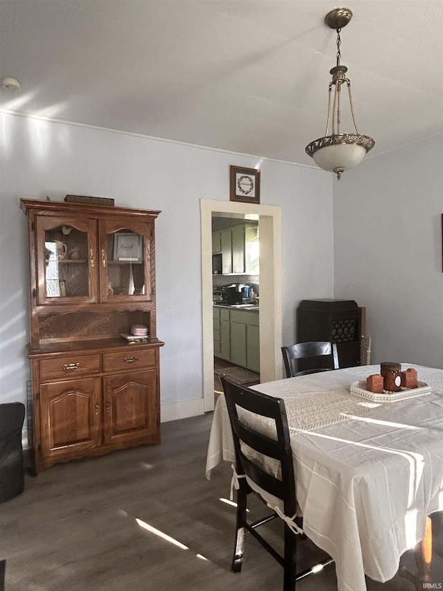 dining area with dark wood finished floors and baseboards