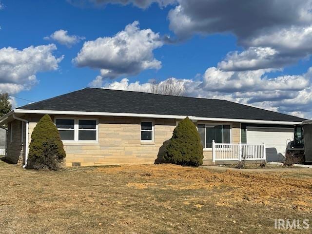 exterior space featuring an attached garage and roof with shingles