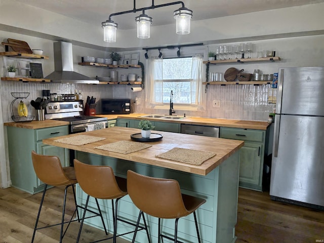 kitchen with open shelves, wall chimney exhaust hood, stainless steel appliances, and wooden counters