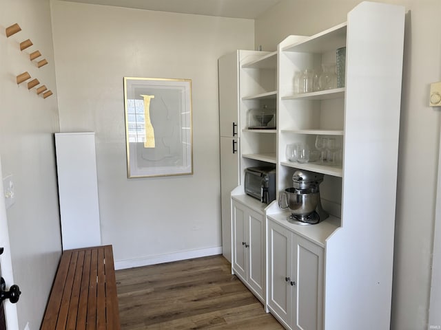 bar featuring baseboards and wood finished floors