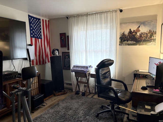 home office with a baseboard radiator and wood finished floors