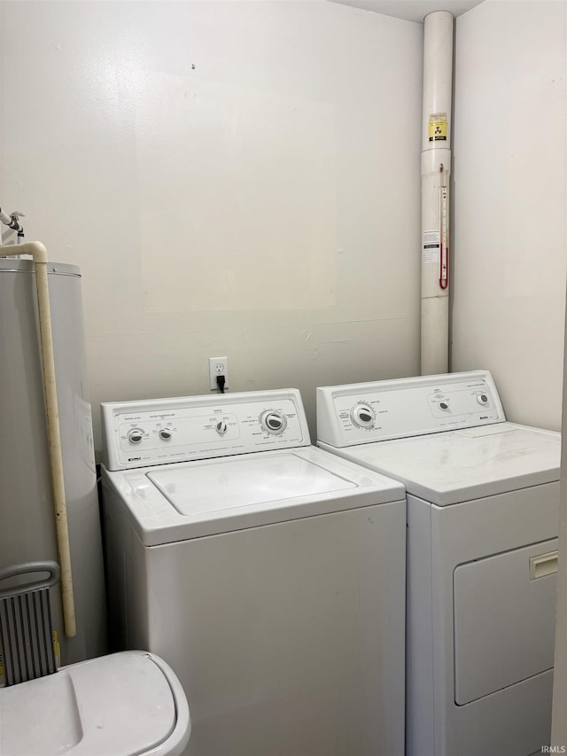 washroom featuring gas water heater and washing machine and clothes dryer