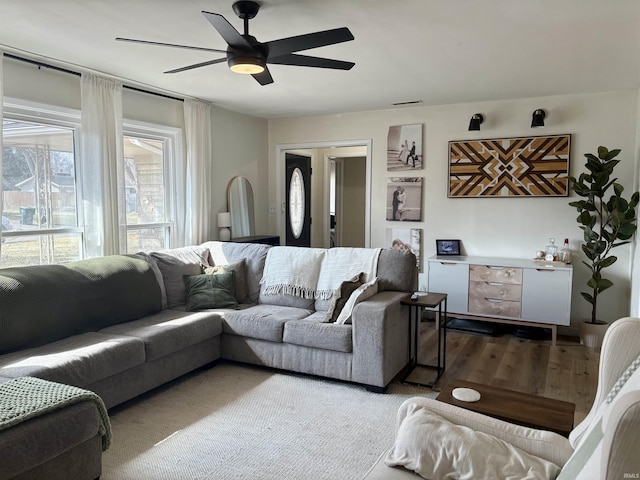 living room featuring a ceiling fan and wood finished floors