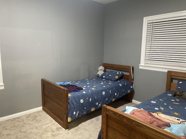 bedroom with baseboards and carpet flooring