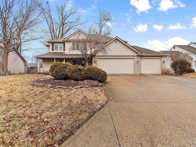 traditional home featuring a garage and concrete driveway