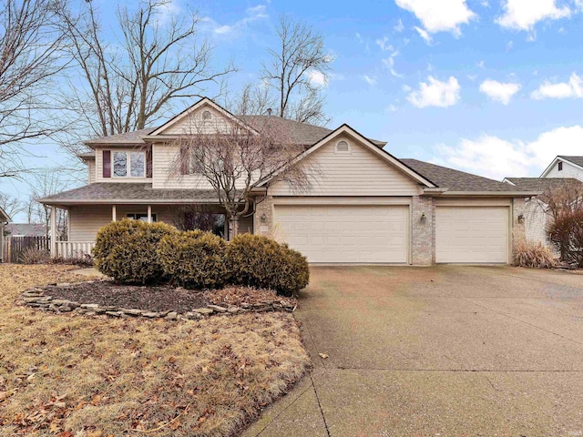 traditional home with driveway, a shingled roof, and an attached garage