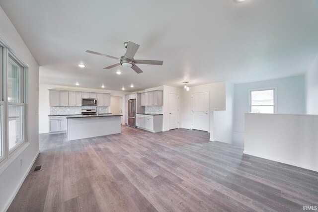 unfurnished living room with recessed lighting, visible vents, ceiling fan, and wood finished floors