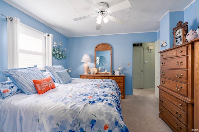 bedroom featuring light carpet, visible vents, a ceiling fan, and crown molding