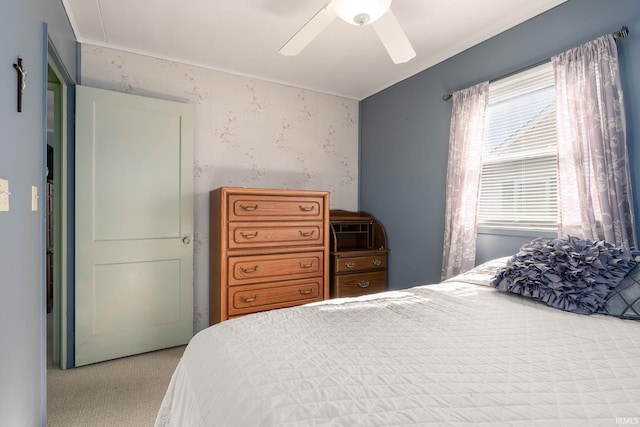 bedroom with carpet flooring, a ceiling fan, and wallpapered walls