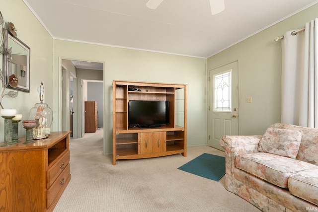 living area featuring a ceiling fan, light carpet, and crown molding