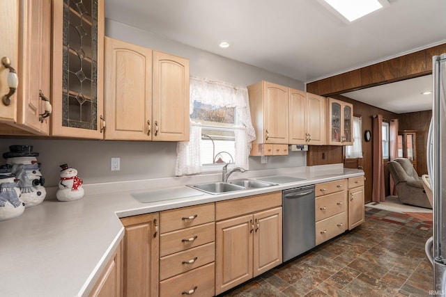 kitchen featuring dishwasher, stone finish floor, glass insert cabinets, light countertops, and light brown cabinetry