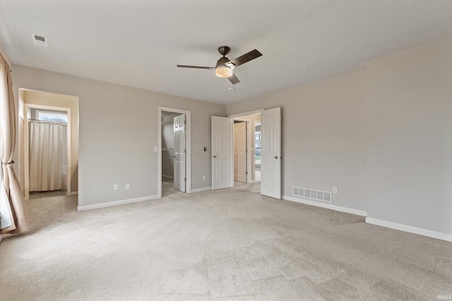 unfurnished bedroom with light colored carpet, visible vents, and baseboards