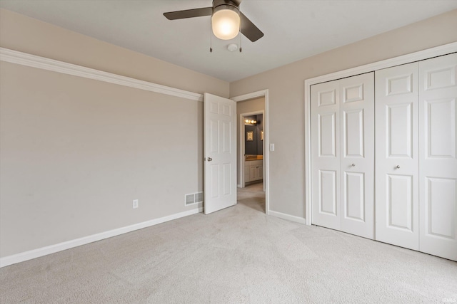 unfurnished bedroom featuring a closet, visible vents, carpet flooring, ceiling fan, and baseboards