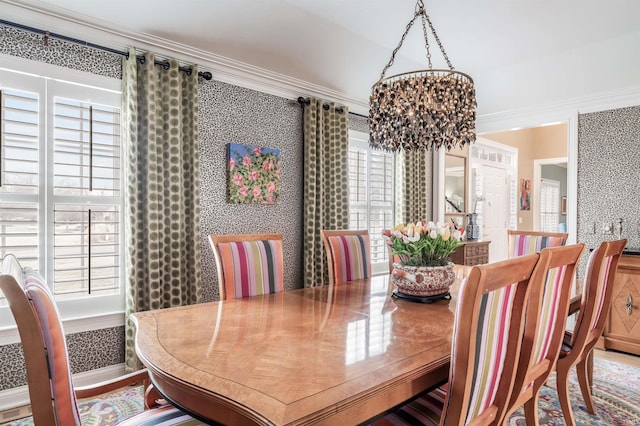 dining space with a chandelier, plenty of natural light, and wallpapered walls