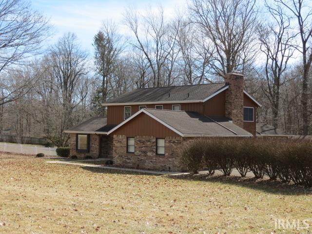 exterior space with a chimney and a front yard