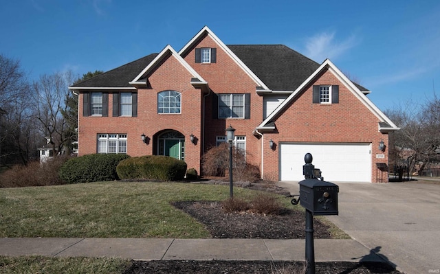 colonial inspired home featuring driveway, brick siding, a garage, and a front yard