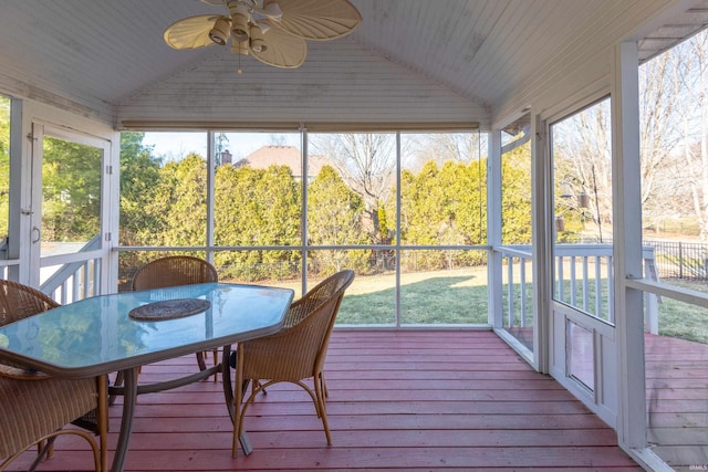 sunroom / solarium featuring vaulted ceiling, a ceiling fan, and a healthy amount of sunlight