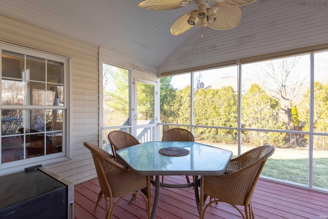 sunroom with ceiling fan and vaulted ceiling