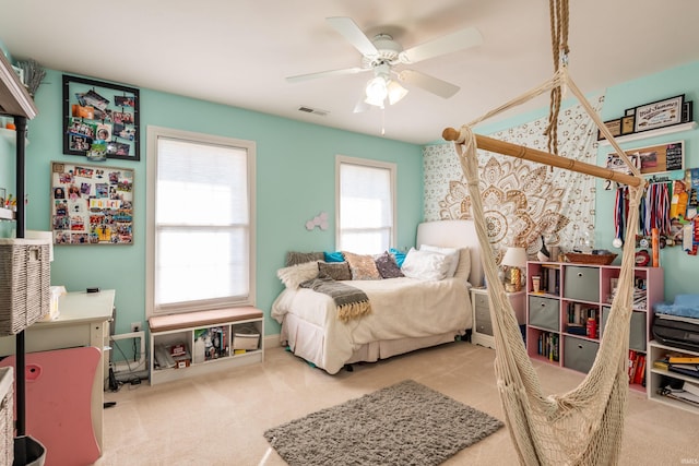 bedroom with visible vents, a ceiling fan, and carpet flooring