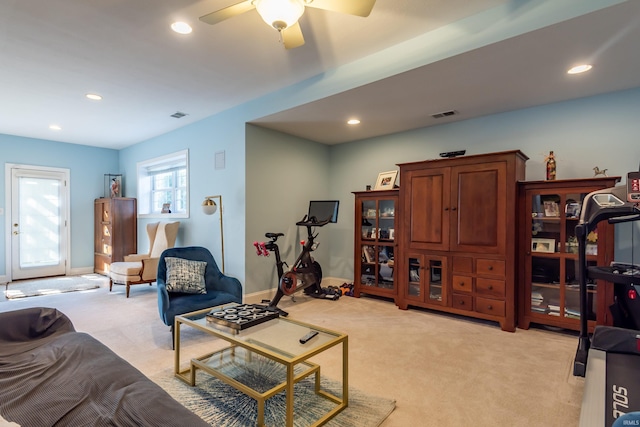 living area with recessed lighting, baseboards, visible vents, and light colored carpet