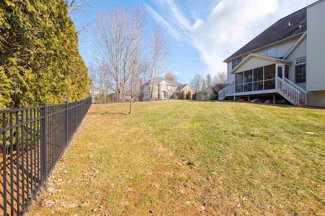 view of yard with a sunroom and a fenced backyard