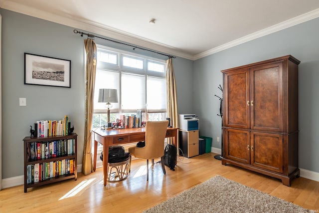 office space featuring a healthy amount of sunlight, light wood-style floors, baseboards, and ornamental molding