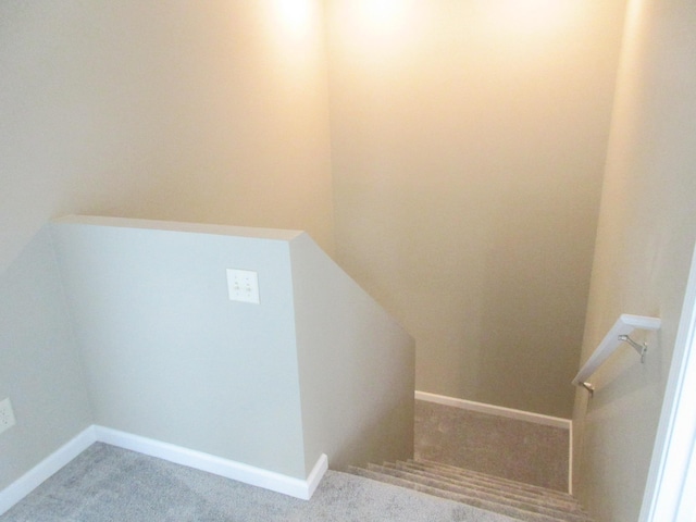 stairway featuring carpet floors and baseboards