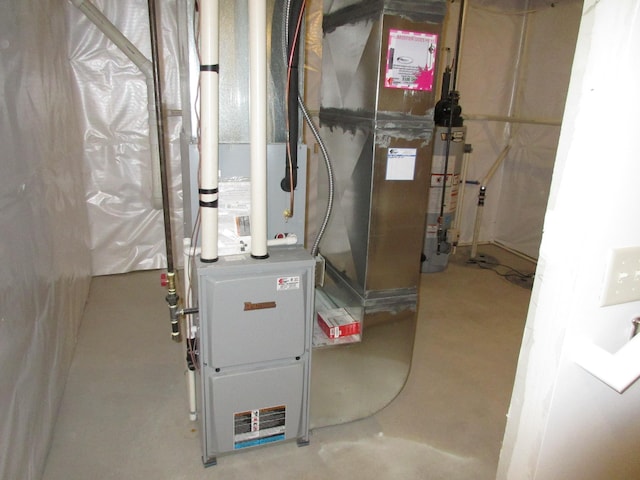 utility room featuring water heater