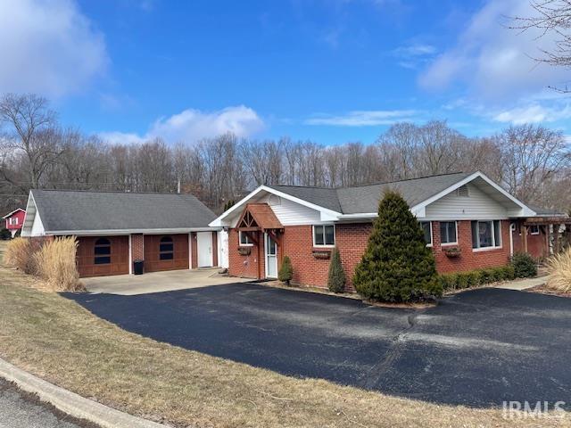 single story home with brick siding and an attached garage