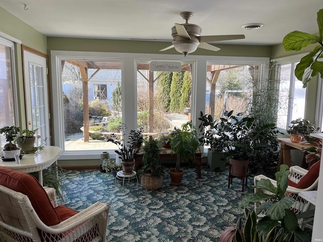 sunroom with a ceiling fan, a healthy amount of sunlight, and visible vents