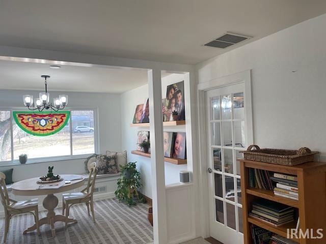 interior space with visible vents and a notable chandelier