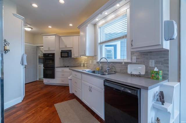 kitchen featuring a sink, white cabinetry, light countertops, black appliances, and dark wood finished floors