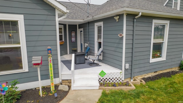 doorway to property featuring a shingled roof