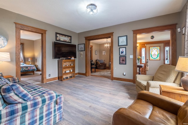 living room with baseboards and light wood finished floors