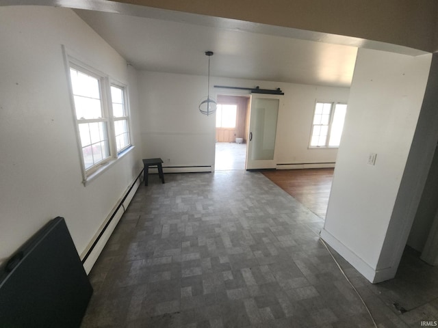 interior space featuring a barn door, baseboards, and baseboard heating