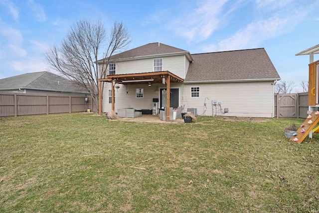 rear view of property featuring a patio area, a fenced backyard, and a lawn