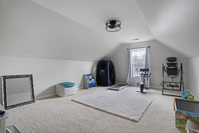 workout area with lofted ceiling, baseboards, visible vents, and carpet flooring