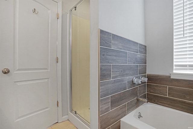 full bath featuring a stall shower, tile patterned flooring, and a bath