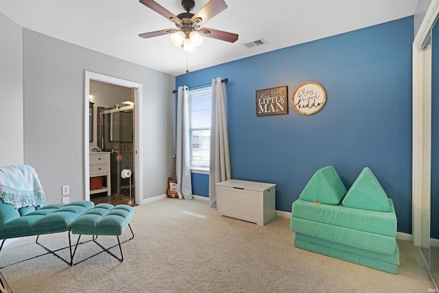 sitting room with baseboards, visible vents, ceiling fan, and carpet flooring