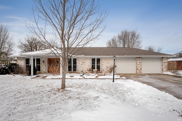 ranch-style home featuring brick siding and an attached garage