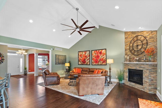 living room with a stone fireplace, visible vents, beam ceiling, hardwood / wood-style floors, and decorative columns