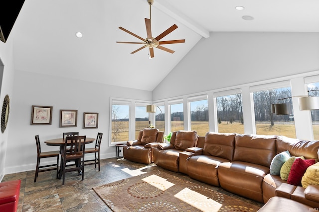 living area with stone tile floors, a ceiling fan, high vaulted ceiling, beamed ceiling, and baseboards