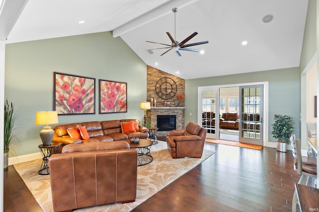 living area with a ceiling fan, wood finished floors, beamed ceiling, a fireplace, and high vaulted ceiling